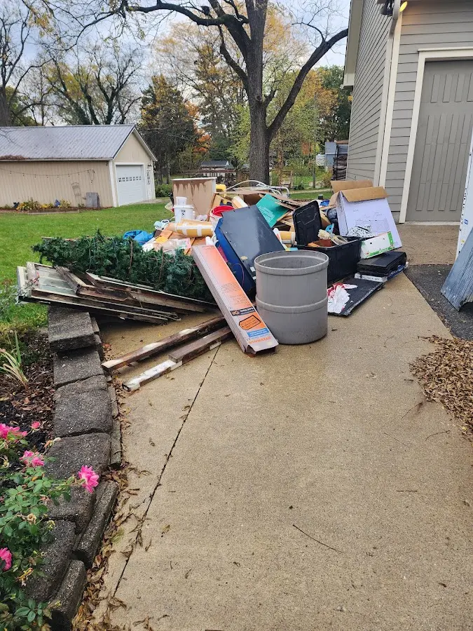 Dumpster being loaded with debris for Roofing Dumpster Rental in Atlas